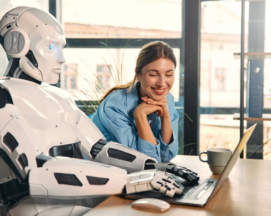 robot-and-woman-working-on-laptop-in-office